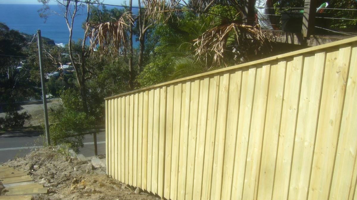 Treated pine timber fence on an elevated Sydney property with water visible in the distance